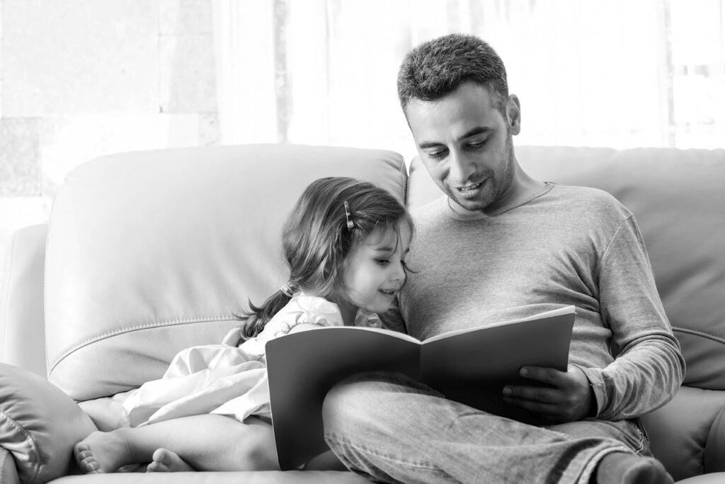 A father reading with his daughter