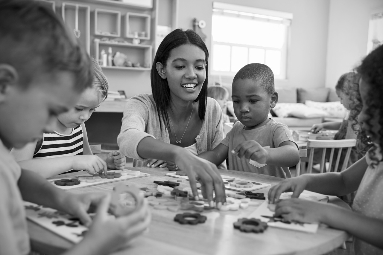 An educator playing with a young child